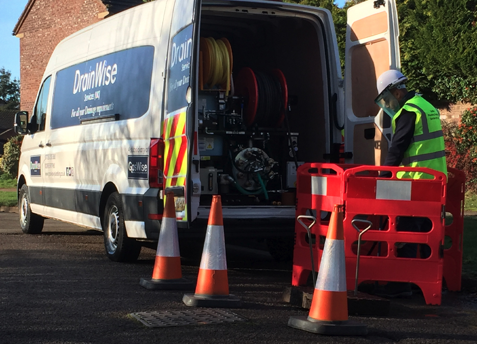Drainwise worker cleaning drain