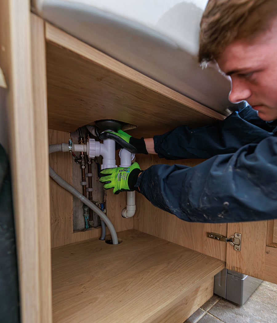 plumber checks under sink