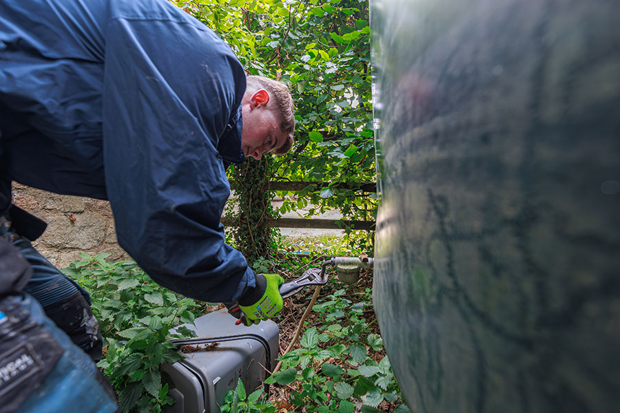 plumber repairing oil tank