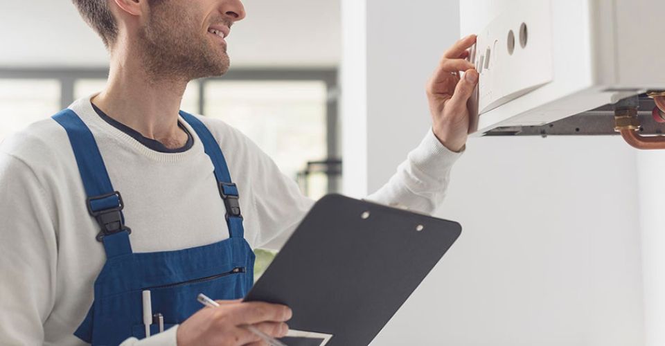 man inspects home boiler