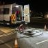 Gaswise company van parked at night beside an open street drain with maintenance equipment and traffic cones set up for drainage work.